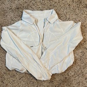 White Lululemon windbreaker. Collared with longer back.